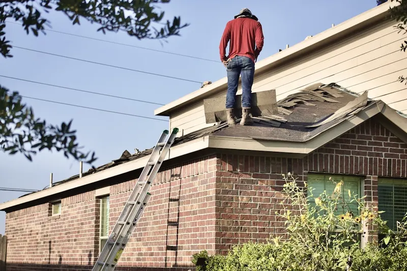 Professional roofer working on a residential roof in Weaversville